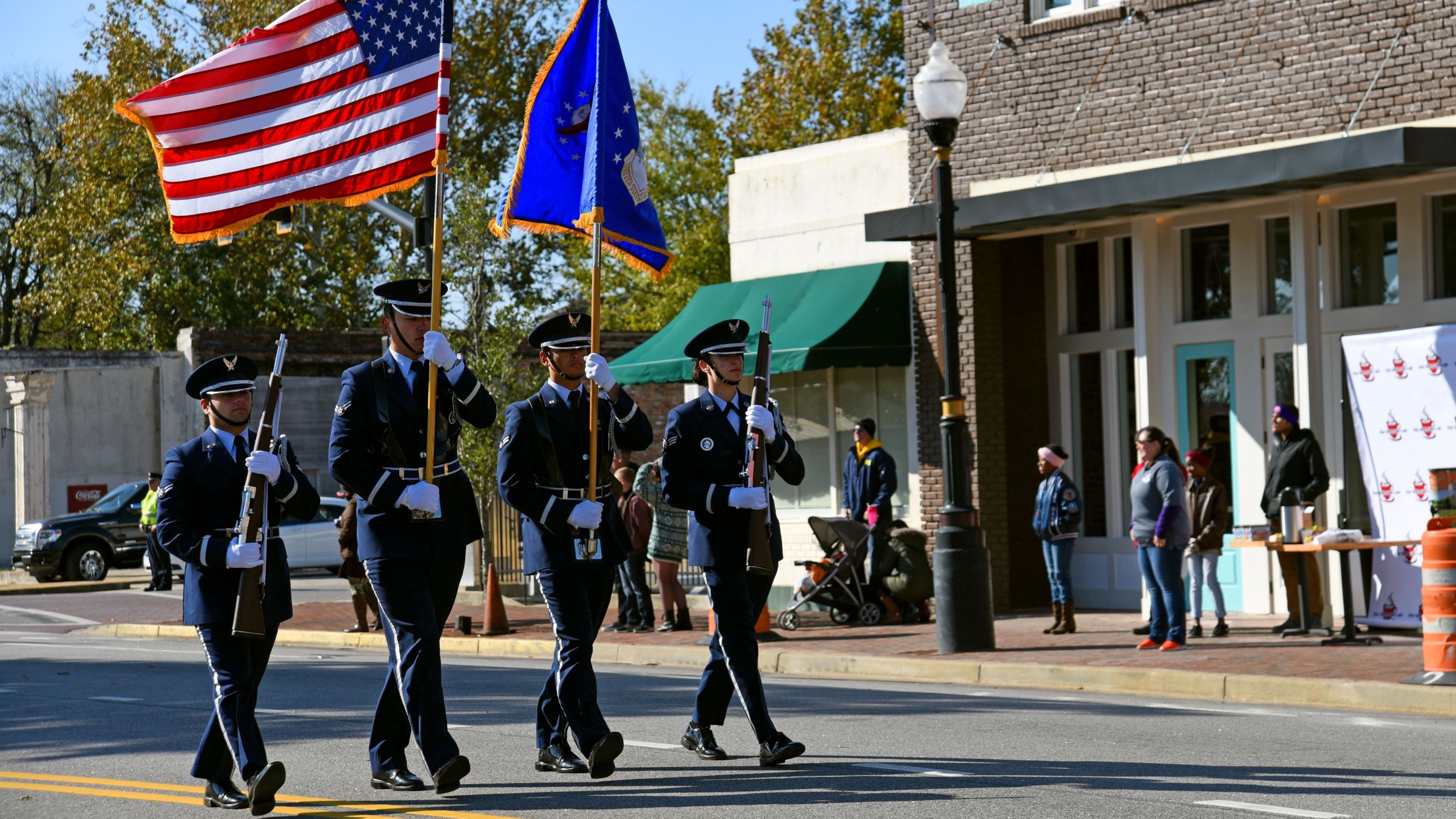 20th Fighter Wing honor guardsmen march holding the U.S. and Air Force flags in downtown Sumter